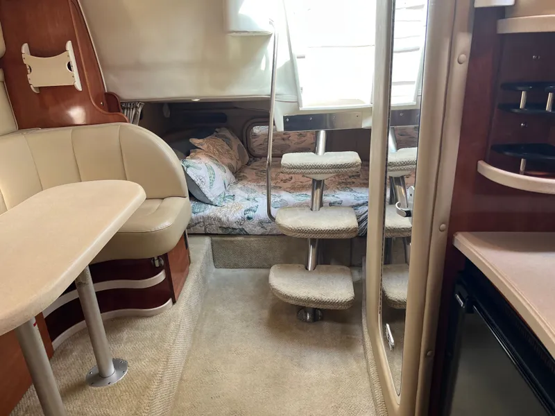 Slide: The Image of Interior of 2003 Rinker Fiesta Vee 342 boat with seating, bed, and stairs. - 16