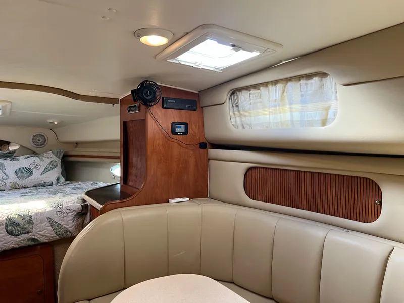 Slide: The Image of 2003 Rinker Fiesta Vee 342 cabin interior with seating, bed, and wood accents. - 17