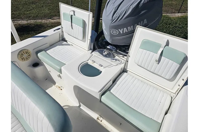 Slide: The Image of 2016 Sundance DX20 boat interior with Yamaha engine, featuring cushioned seating and storage compartments. - 11