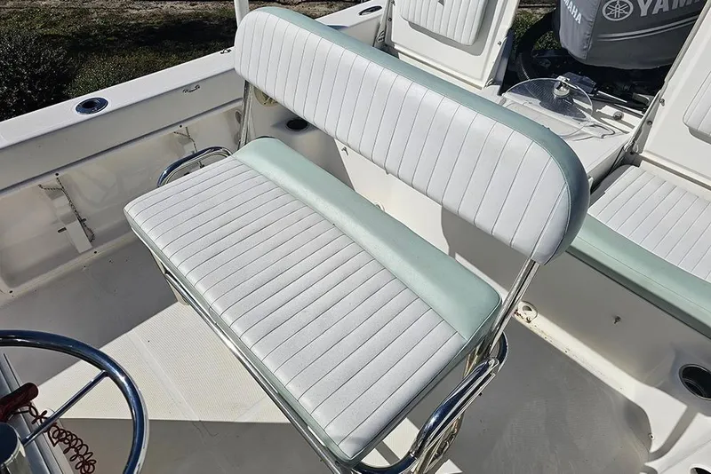 Slide: The Image of 2016 Sundance DX20 boat interior with white and green cushioned seating. - 12