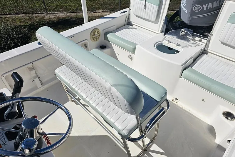 Slide: The Image of 2016 Sundance DX20 boat interior with steering wheel and seating. - 13