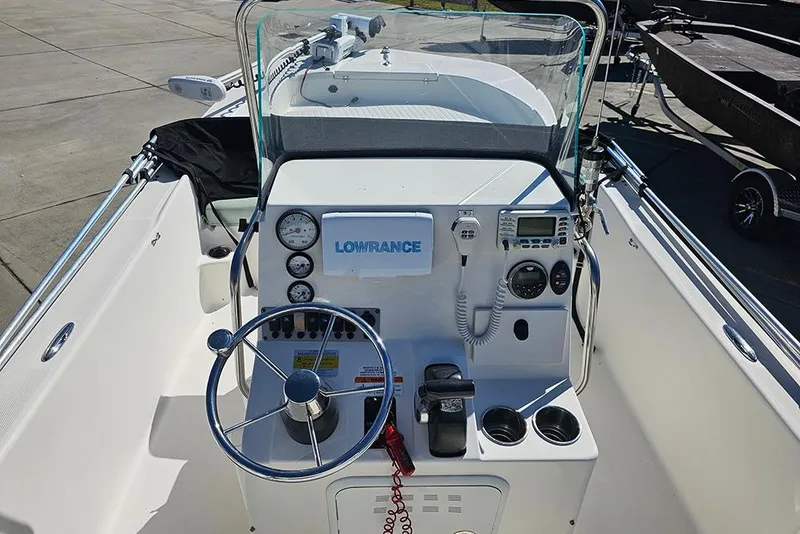 Slide: The Image of 2016 Sundance DX20 boat dashboard with steering wheel, gauges, and Lowrance electronics. - 14