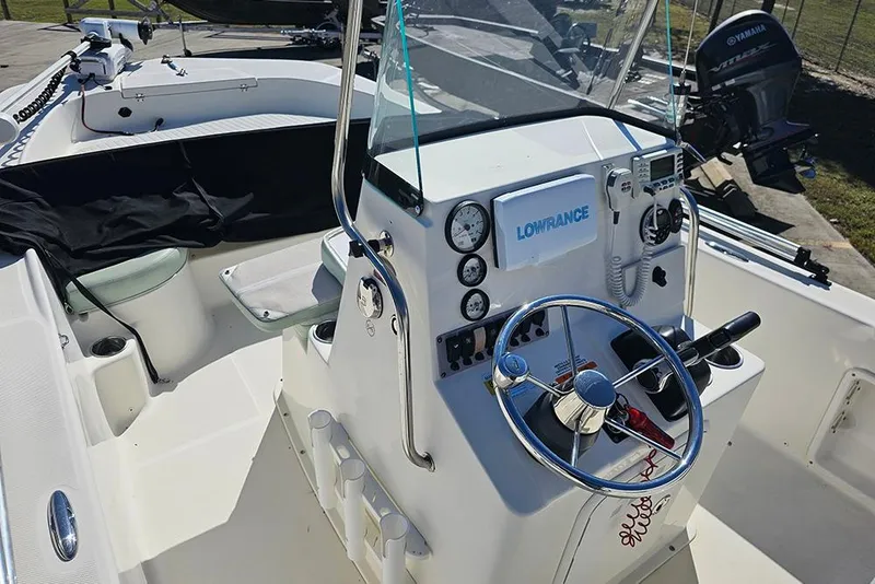 Slide: The Image of 2016 Sundance DX20 boat cockpit with steering wheel and navigation equipment. - 15