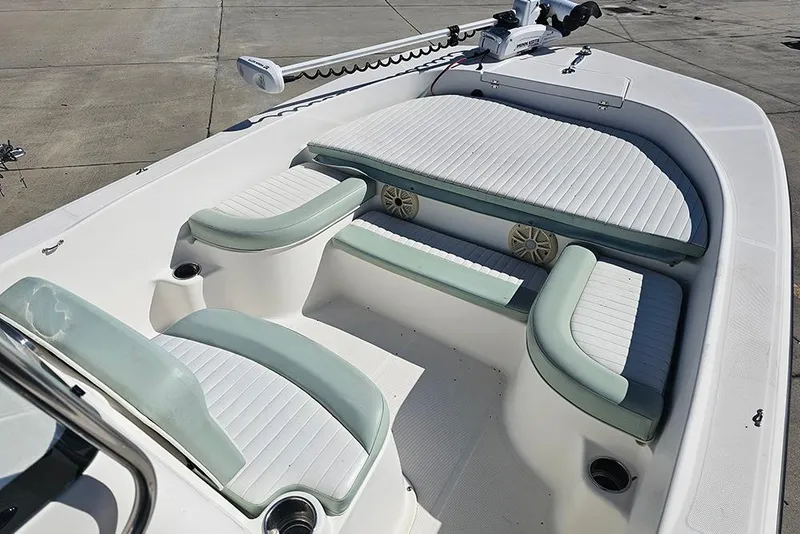 Slide: The Image of 2016 Sundance DX20 boat interior with cushioned seating and speakers. - 16