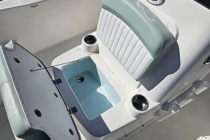 Slide: The Image of 2016 Sundance DX20 boat interior with open storage compartment and cushioned seating. - 18