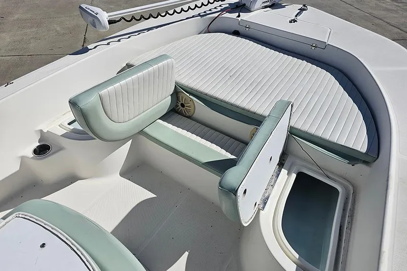 Slide: The Image of 2016 Sundance DX20 boat interior with cushioned seating and storage compartments. - 19