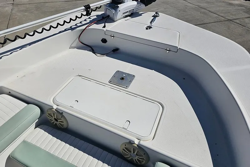Slide: The Image of 2016 Sundance DX20 boat deck with storage compartments and seating. - 20