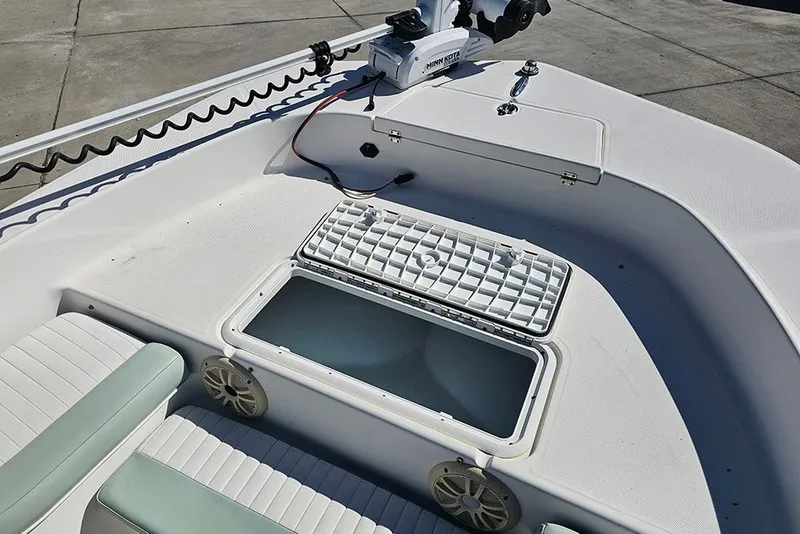 Slide: The Image of 2016 Sundance DX20 boat interior with storage compartment and seating. - 21