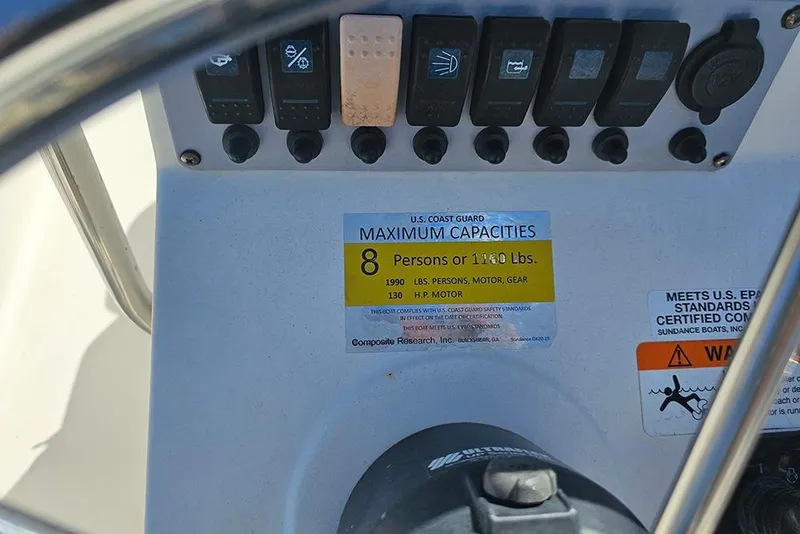 Slide: The Image of 2016 Sundance DX20 boat capacity label, showing maximum of 8 persons or 1180 lbs. - 23