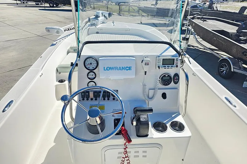 Slide: The Image of 2016 Sundance DX20 boat dashboard with steering wheel and navigation equipment. - 24