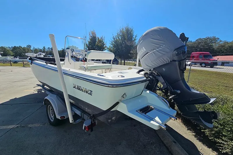 Slide: The Image of 2016 Sundance DX20 boat with Yamaha outboard motor on trailer, parked outdoors. - 3