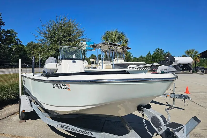 Slide: The Image of 2016 Sundance DX20 boat on trailer in sunny outdoor setting. - 5