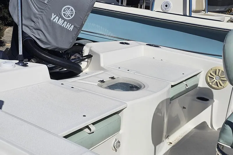 Slide: The Image of 2016 Sundance DX20 boat interior with Yamaha engine cover and seating area. - 9