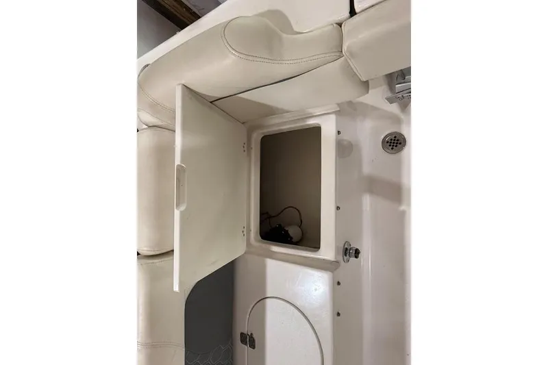 Slide: The Image of 2017 Tidewater 210 LXF boat interior storage compartment with open hatch. - 13