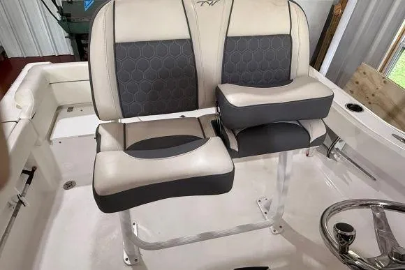 Slide: The Image of 2017 Tidewater 210 LXF boat interior with dual cushioned seats and steering wheel. - 16