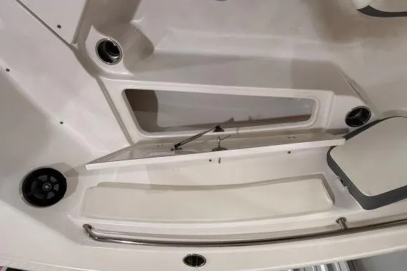Slide: The Image of 2017 Tidewater 210 LXF boat interior, featuring storage compartment and stainless steel railing. - 18