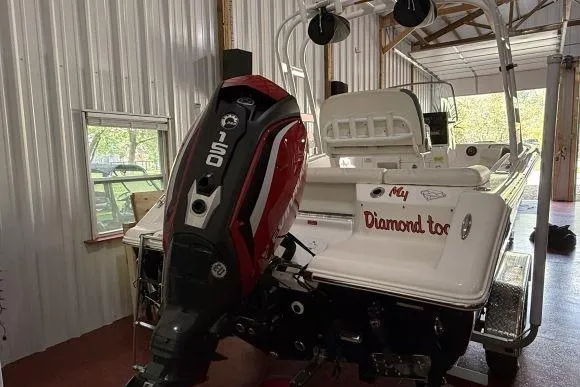 Slide: The Image of 2017 Tidewater 210 LXF boat with 150 HP engine in a garage setting. - 3