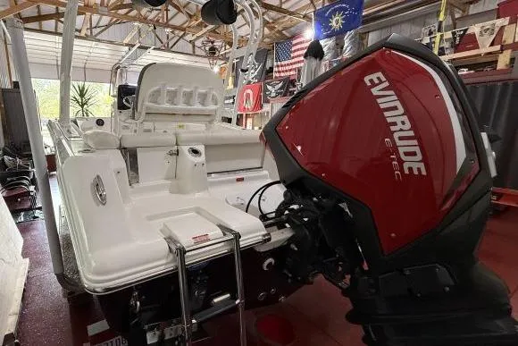 Slide: The Image of 2017 Tidewater 210 LXF boat with Evinrude E-TEC engine in a garage setting. - 8