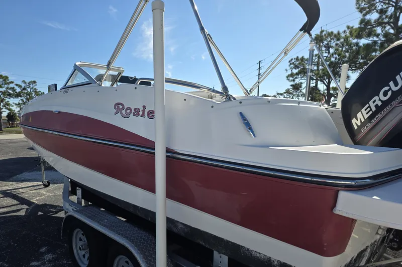 Slide: The Image of 2013 Bayliner 190 Deck Boat "Rosie" with Mercury engine on trailer. - 2