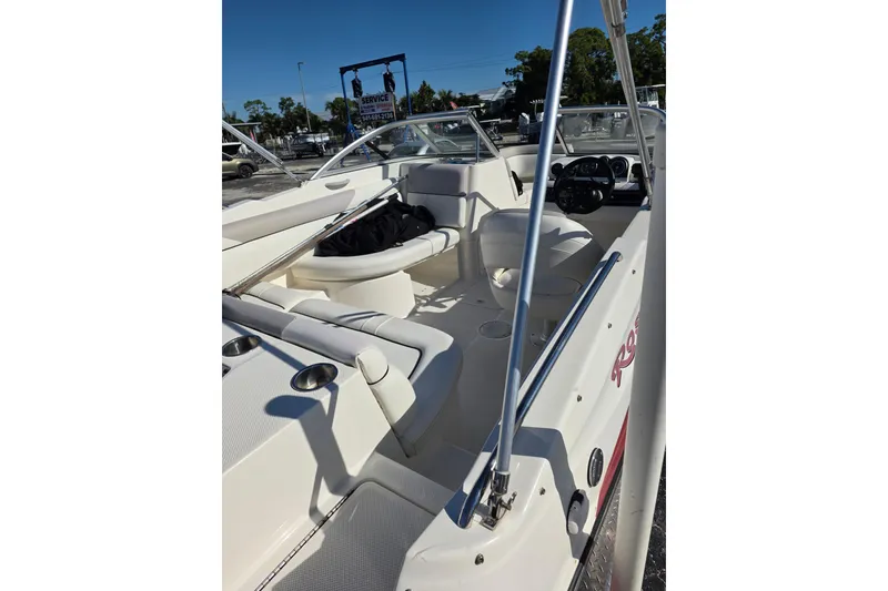 Slide: The Image of 2013 Bayliner 190 Deck Boat interior with seating and steering console. - 7