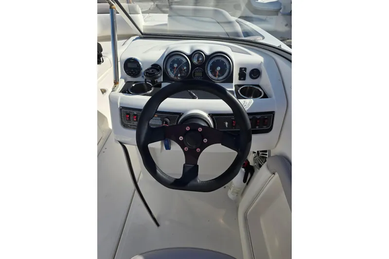 Slide: The Image of 2013 Bayliner 190 Deck Boat dashboard with steering wheel and gauges. - 9
