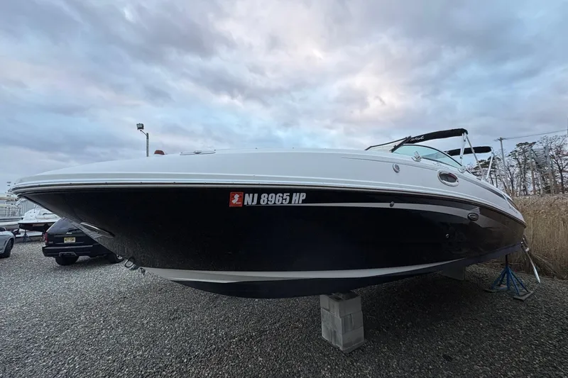 The Image of 2013 Sea Ray 280 Sundeck boat with white exterior, docked at a marina. - 0