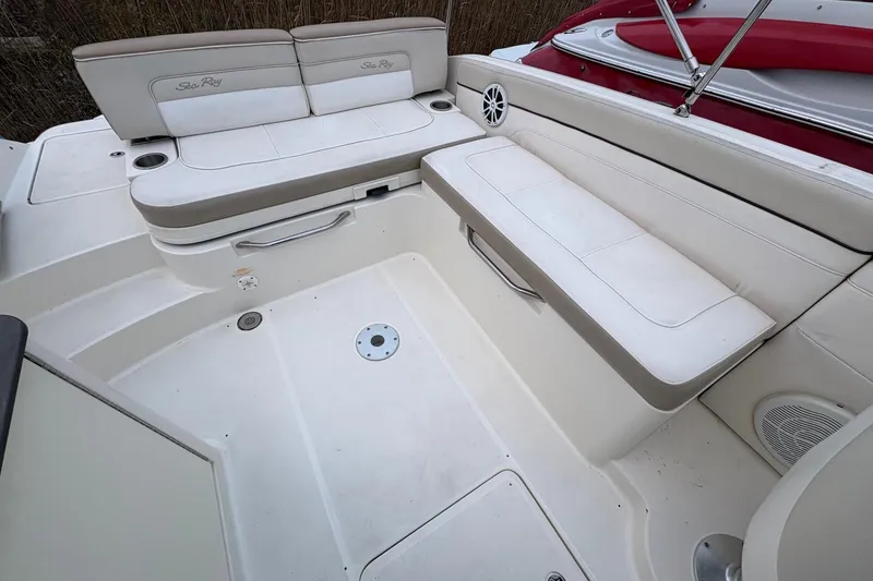 Slide: The Image of 2013 Sea Ray 280 Sundeck interior with white seating and cup holders. - 11