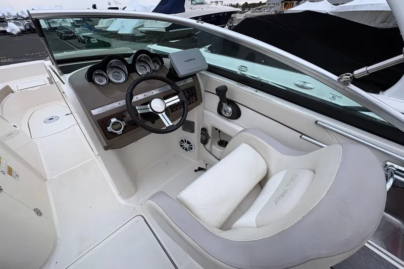 Slide: The Image of 2013 Sea Ray 280 Sundeck cockpit with steering wheel and navigation system. - 12