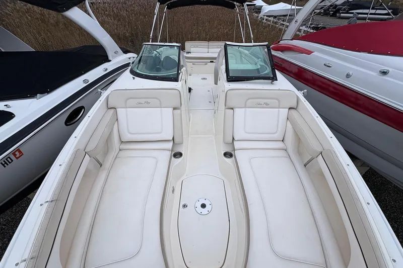 Slide: The Image of 2013 Sea Ray 280 Sundeck boat interior with white seating and dual windshields. - 16
