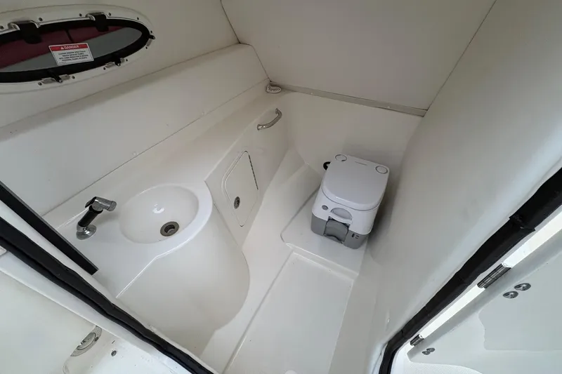 Slide: The Image of Interior of 2013 Sea Ray 280 Sundeck boat bathroom with sink and portable toilet. - 17