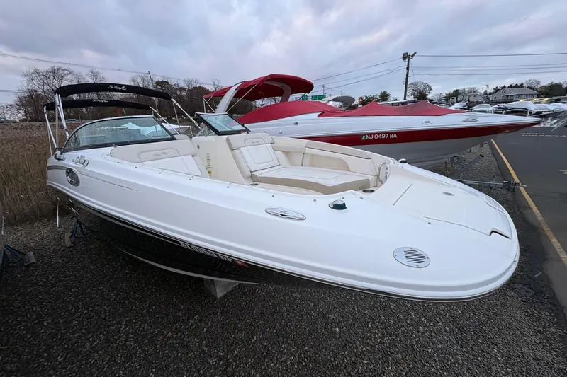 Slide: The Image of 2013 Sea Ray 280 Sundeck boat on gravel, cloudy sky background. - 2