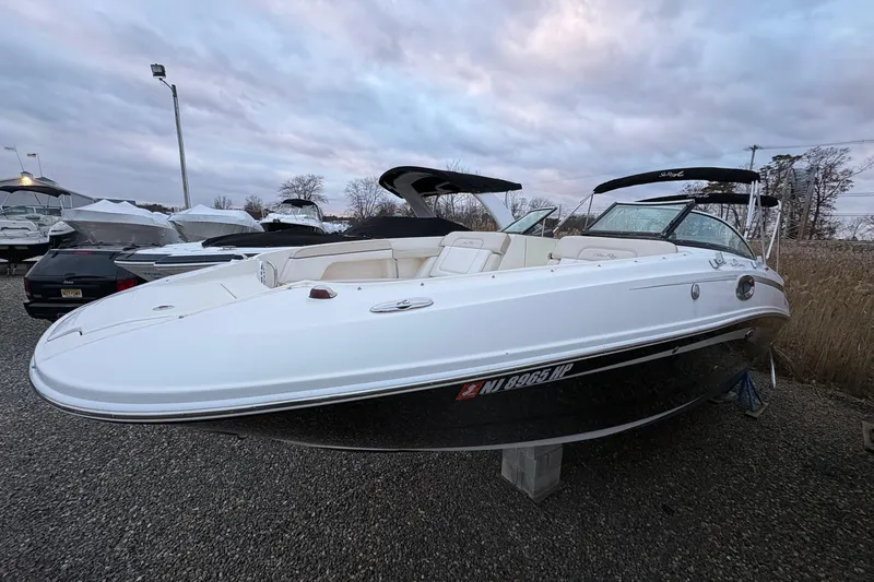 Slide: The Image of 2013 Sea Ray 280 Sundeck boat displayed outdoors on gravel. - 3