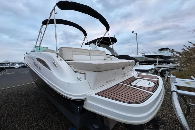 Slide: The Image of 2013 Sea Ray 280 Sundeck boat on display in a marina setting. - 4