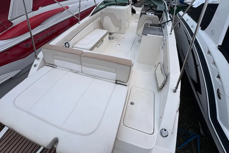 Slide: The Image of 2013 Sea Ray 280 Sundeck boat interior with white seating and dashboard. - 8