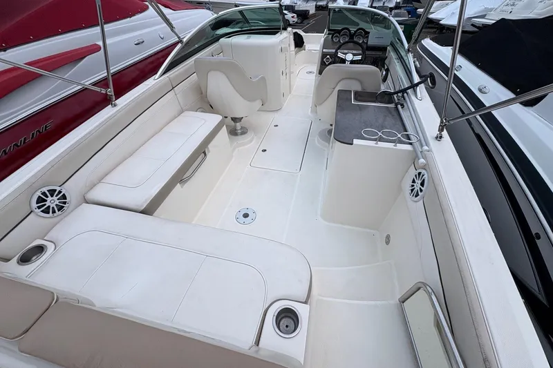 Slide: The Image of 2013 Sea Ray 280 Sundeck interior with white seating and helm. - 9