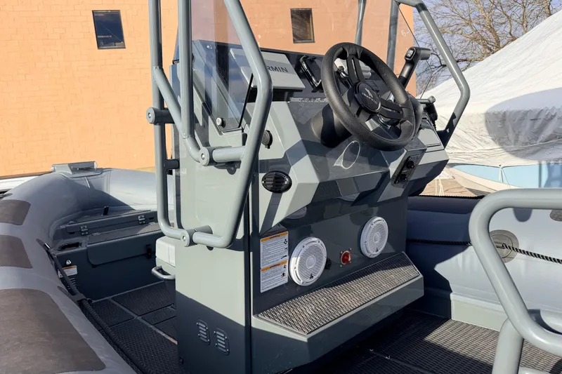 Slide: The Image of 2026 Highfield Patrol 660 boat console with steering wheel and controls. - 12