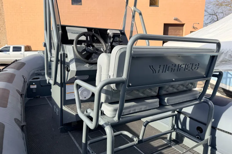 Slide: The Image of 2026 Highfield Patrol 660 boat interior with steering wheel and seating. - 14