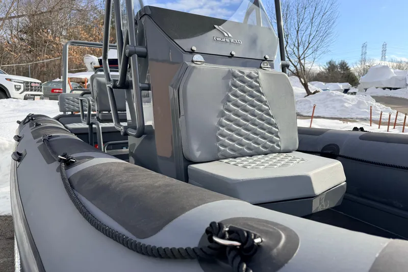 Slide: The Image of 2026 Highfield Patrol 660 boat with quilted seating, parked in snowy outdoor setting. - 17