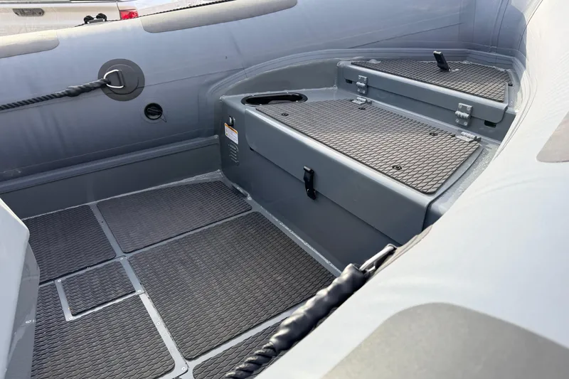 Slide: The Image of Interior of 2026 Highfield Patrol 660 boat showing storage compartments and non-slip flooring. - 19