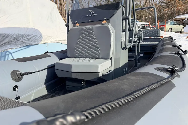 Slide: The Image of 2026 Highfield Patrol 660 boat interior with gray seating and control console. - 7