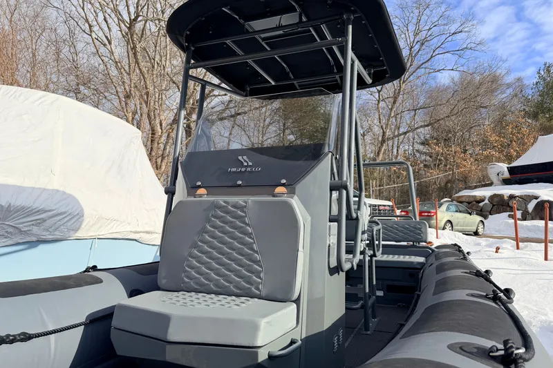 Slide: The Image of 2026 Highfield Patrol 660 boat with sleek design, parked in snowy outdoor setting. - 9