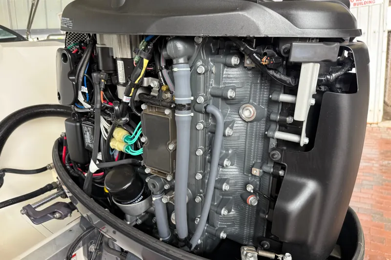 Slide: The Image of Close-up of a 2023 NauticStar 243 DC boat engine, showcasing intricate components. - 16