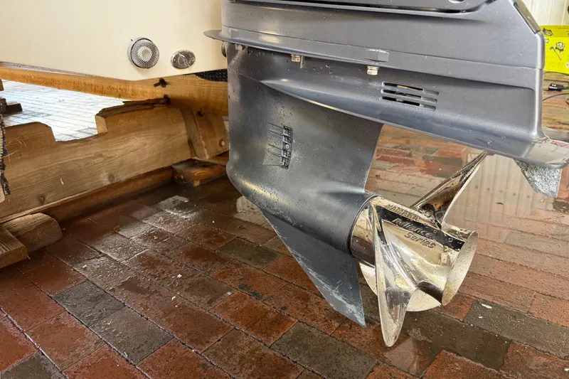 Slide: The Image of 2023 NauticStar 243 DC boat propeller on brick surface, showcasing sleek design. - 17