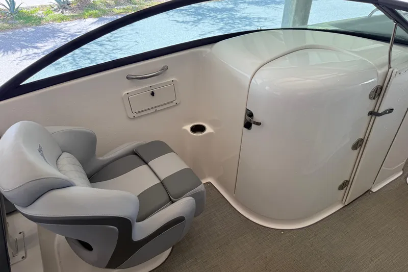 Slide: The Image of 2023 NauticStar 243 DC boat interior with gray seating and storage compartment. - 32