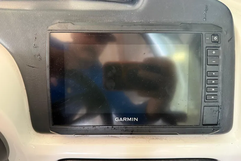 Slide: The Image of Garmin navigation system on 2023 NauticStar 243 DC boat dashboard. - 42
