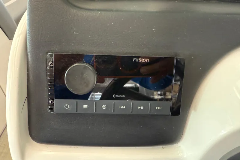 Slide: The Image of Fusion audio system on 2023 NauticStar 243 DC boat dashboard. - 43