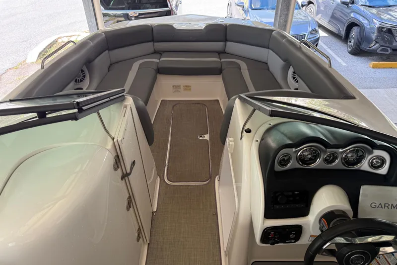 Slide: The Image of 2023 NauticStar 243 DC boat interior with seating and dashboard view. - 46