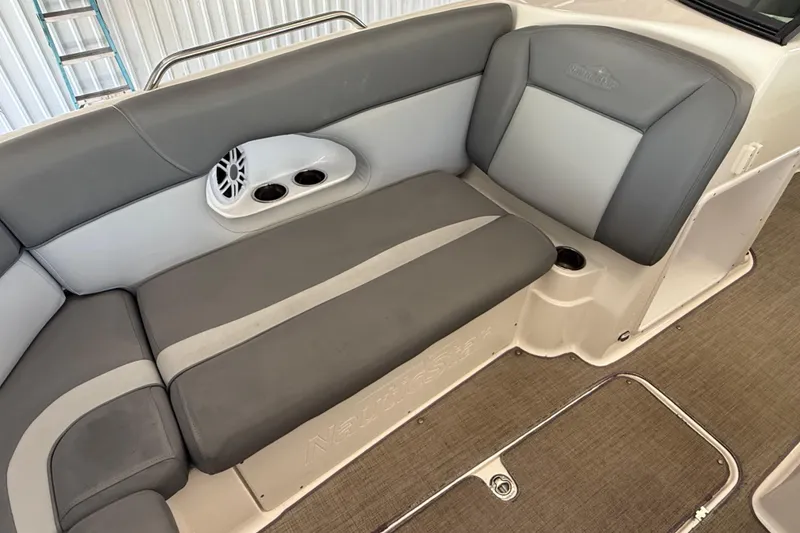 Slide: The Image of 2023 NauticStar 243 DC boat interior with gray seating and cup holders. - 47