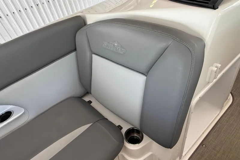 Slide: The Image of 2023 NauticStar 243 DC boat interior with gray seating and cup holder. - 50