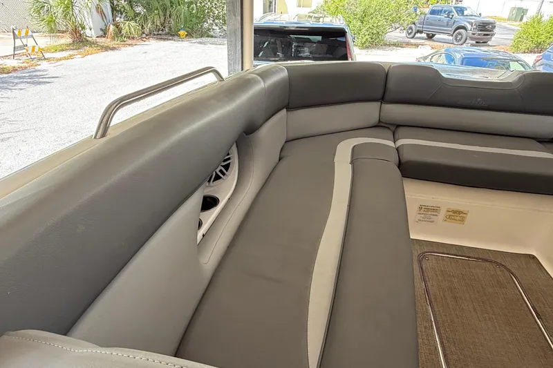 Slide: The Image of 2023 NauticStar 243 DC boat interior with gray seating and speaker detail. - 53